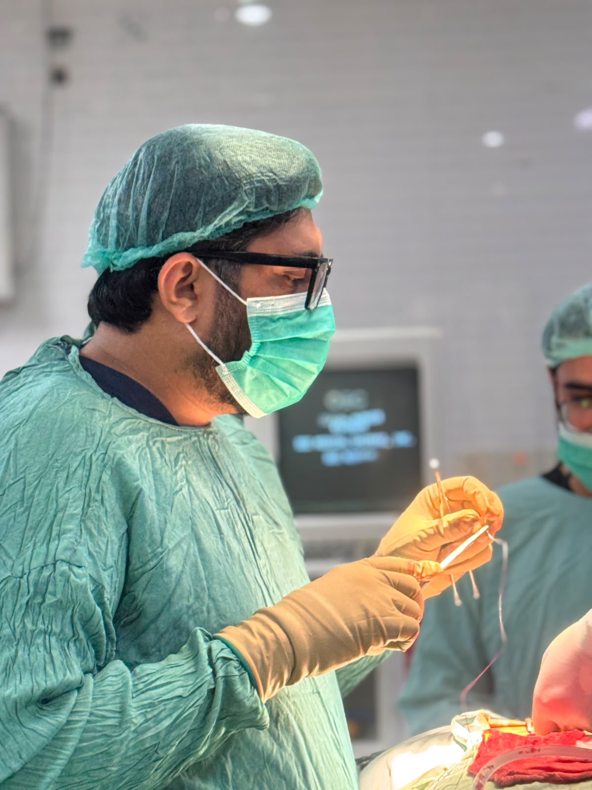 Dr. Arslan Ali focused during an orthopedic surgical procedure